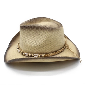 Detail of high-density straw cowboy hat featuring shell and wooden bead decorations
