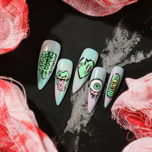 Halloween stiletto press-on nails featuring spooky brain, eyeball, and bite hand-painted art