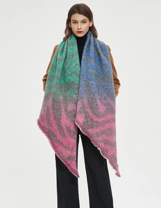 Detail of colorful plaid scarf with fuzzy texture and fringe tassels on model
