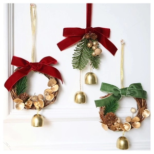 Detailed view of Christmas mini wreaths with velvet bows, bells and pine cone accents