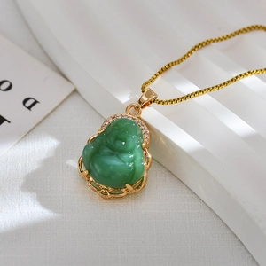 Macro detail of Maitreya Buddha pendant with green stone and gold plating finish