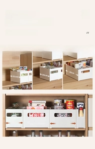 Detailed view of various white kitchen organizers with handle cutouts and multiple sizes