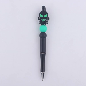 Detail of DIY beadable pen featuring a black cartoon spider figure with green eyes