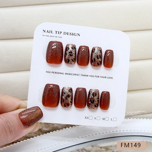 Caramel leopard print press-on nails with cat-eye glitter effect on display card