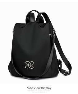 Side view of black anti-theft backpack showing waterproof fabric and silver geometric buckle