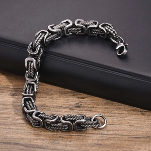 Macro view of vintage silver stainless steel Byzantine chain with robust lobster clasp closure