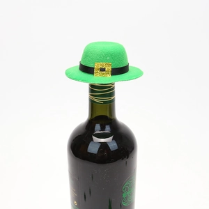 Macro detail of a green felt St. Patrick's mini bottle hat with a gold glitter buckle decoration