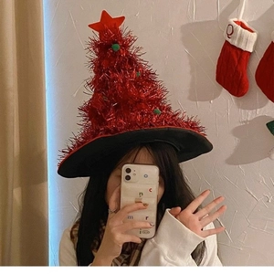 Sparkly red tinsel Christmas tree hat with pom-poms and star for holiday party costumes