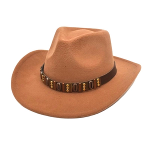 Detail of the brown felt cowboy hat with a decorative studded leather band on white background