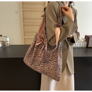 Detail of leopard print canvas tote bag with side bow tie detail on shoulder