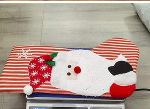 Detailed view of red and white striped Christmas stocking with a 3D Santa Claus applique