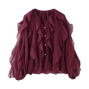 Detailed view of burgundy V-neck chiffon shirt with ruffle layers and button closure