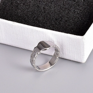 Macro detail of silver titanium steel ring with flat top and geometric textured band