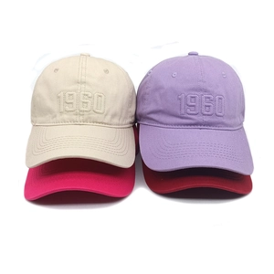 Classic 1960 embroidered baseball caps in beige, lavender, and red colors on white backdrop