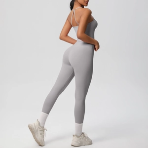 Detail of cross-back yoga bodysuit showing thin straps and light grey athletic fabric