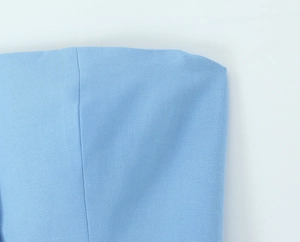 Detailed macro view of the blue cotton blend fabric texture on the tube top and pants set