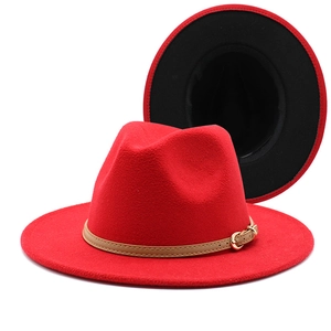 Detail of red wool fedora with brown leather band, gold buckle and black lining