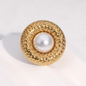 Minimalist 18k gold plated hammered ring with white pearl on white stone surface