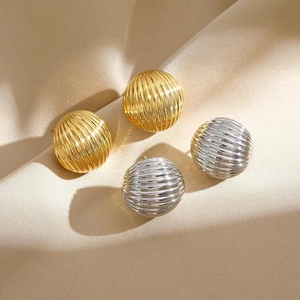 Polished gold and silver spherical stud earrings with textured vertical ridges
