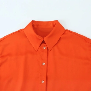 Bright orange long sleeve satin shirt with lapel collar and detailed twill texture