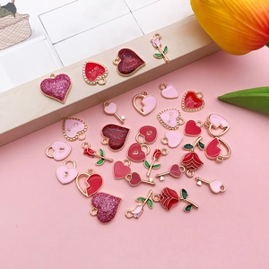Flat lay of heart and rose charms for DIY jewelry making in red and pink colors