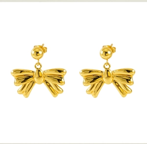 Macro detail of 18k gold plated stainless steel bow earrings with a polished finish