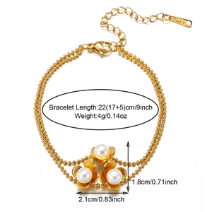 Detailed view of 18k gold plated shell flower bracelet with pearls and size specifications