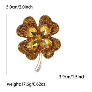 Golden clover brooch with rhinestones including size 5x3.9cm and weight specifications