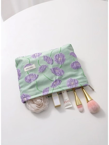 Floral canvas makeup bag in light green with purple patterns and beauty tools