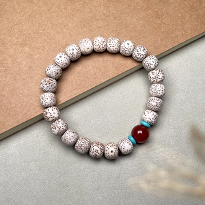Detailed macro shot of Xingyue Bodhi seeds with red agate bead and turquoise spacers