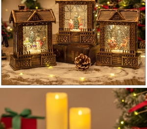 Close-up of Christmas lantern house with spinning snowflakes and Santa Claus scenery