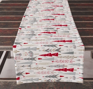 Detail of Christmas table runner with festive tree pattern on rustic wooden table