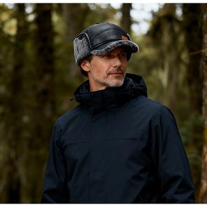 Men's winter leather hat with fur ear flaps and logo detail for outdoor protection