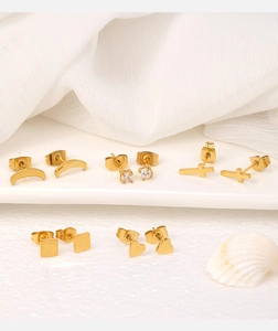 Detailed set of five 18K gold-plated studs featuring moon, heart, and cross designs