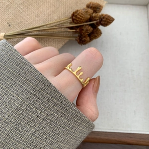 Polished golden crown water drop ring with irregular liquid design on a finger