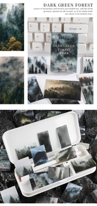 Macro detail of Dark Forest theme stickers with misty woodland photography on a desk