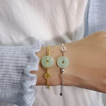 Close-up of gold and silver layered bracelets with turquoise stone on a woman's wrist