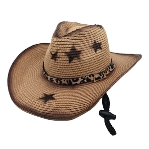 Detail of vintage straw cowboy hat with leopard print band and metal buckle accents