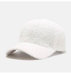 Close-up detail of soft white faux shearling fabric on a classic baseball cap