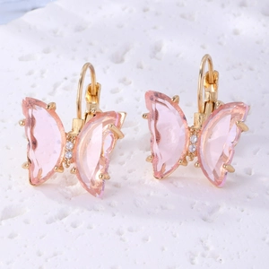 Detailed view of elegant pink crystal butterfly earrings with golden metal frames