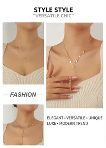 Close-up of a gold-plated Y-shaped tassel necklace with heart and disc pendant details