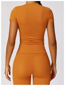 Rear view of quick-dry yoga set showing the V-shaped seam detail in ginger yellow color