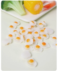 Macro detail of miniature resin fried eggs for DIY crafts and dollhouse decorations