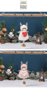 Detail of plush Christmas angel ornaments with Love and Peace hearts in a winter setting