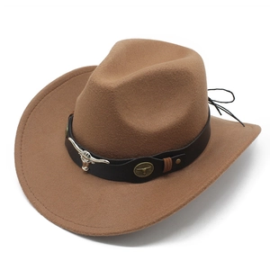 Detail of brown western cowboy hat with leather band and metal bull head ornaments