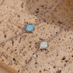 Stainless steel pear-shaped opal pendant necklace, delicate chain with sparkling micro-inlaid stones.