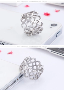 Close-up of wide stainless steel ring with infinity symbols and matte brushed texture