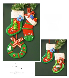 Detailed relief of resin Christmas stocking and wreath ornaments with festive 3D bow accents