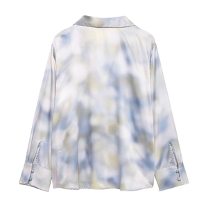 Detail of satin tie-dye shirt back with elegant blue and yellow watercolor patterns