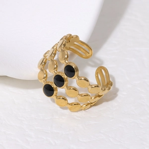 Detail of 18K gold plated stainless steel triple-layer ring with black enamel dots